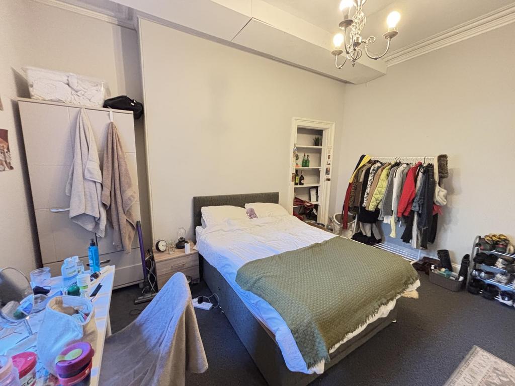 A well-maintained bedroom featuring a comfortab...