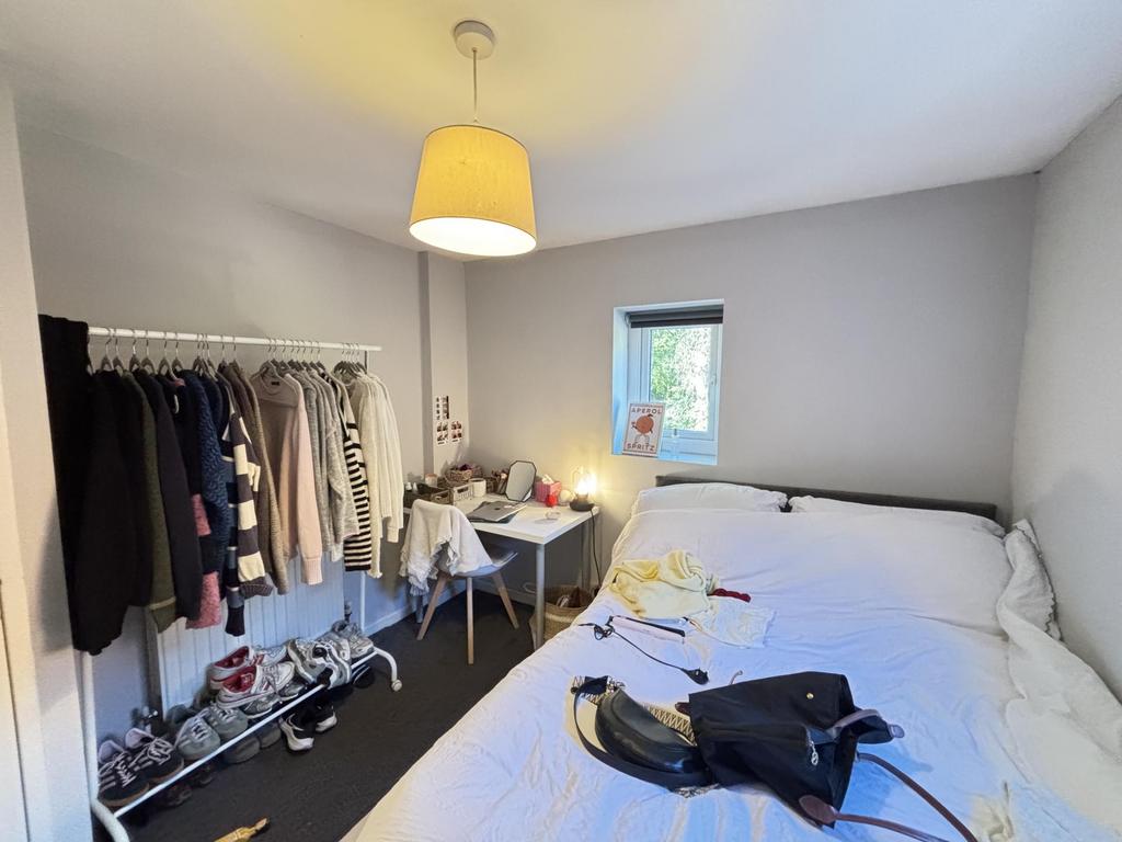 A bright and tidy double bedroom featuring a co...