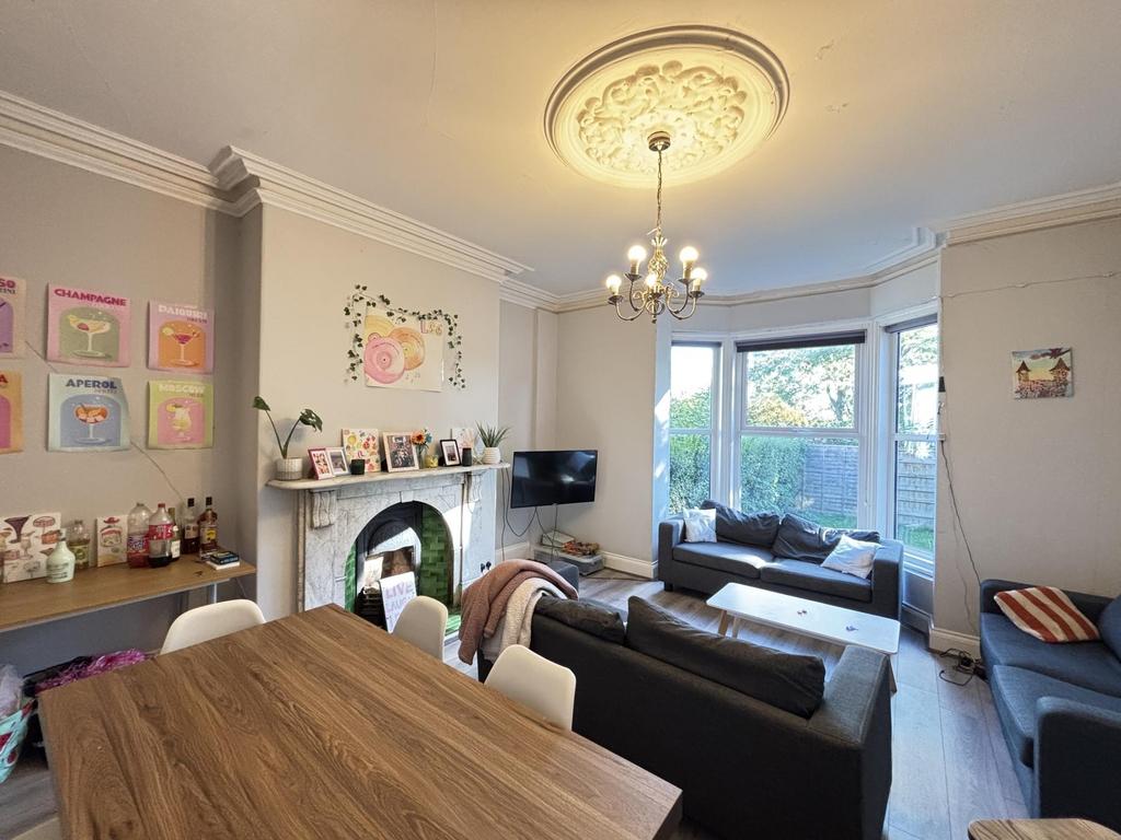 Bright and welcoming living room with ample nat...