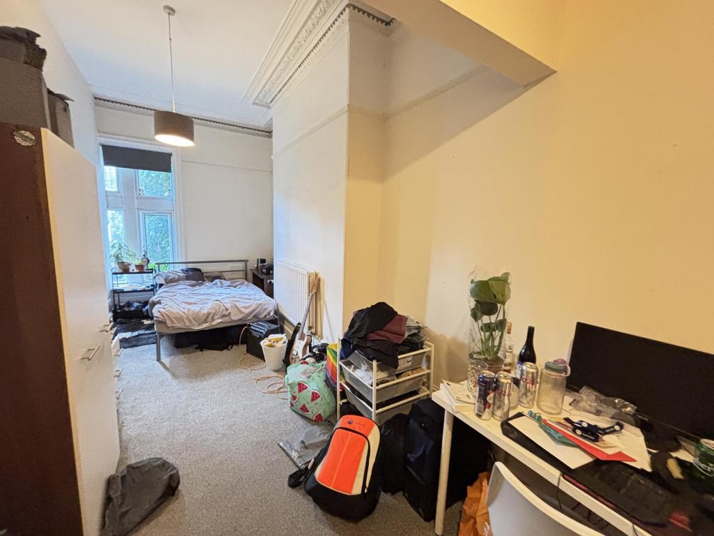 A cozy bedroom with a double bed and a small wo...
