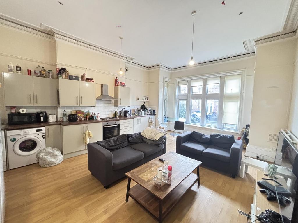 Bright and spacious living room featuring large...