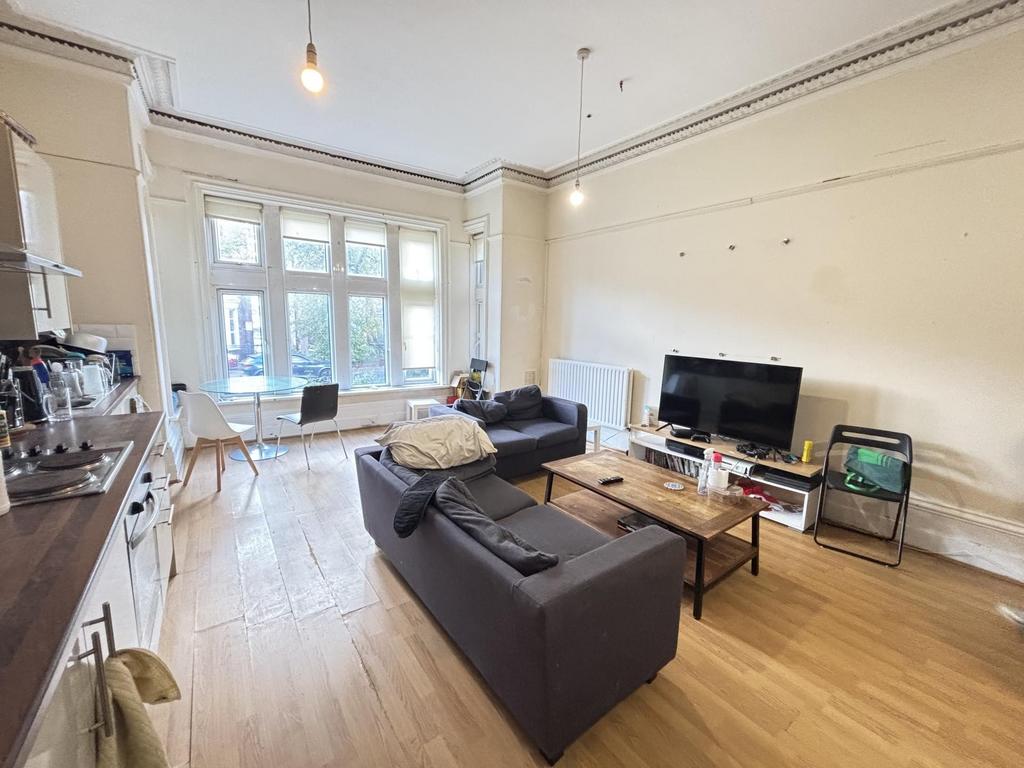 A bright and welcoming living room featuring la...