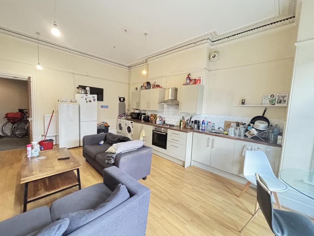 A bright and spacious living room featuring com...