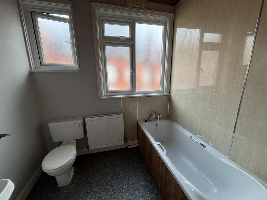 A well-maintained bathroom featuring a large ba...