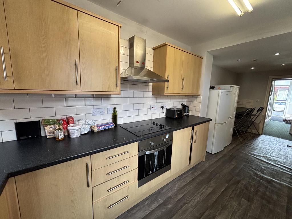 A well-maintained kitchen area with modern wood...