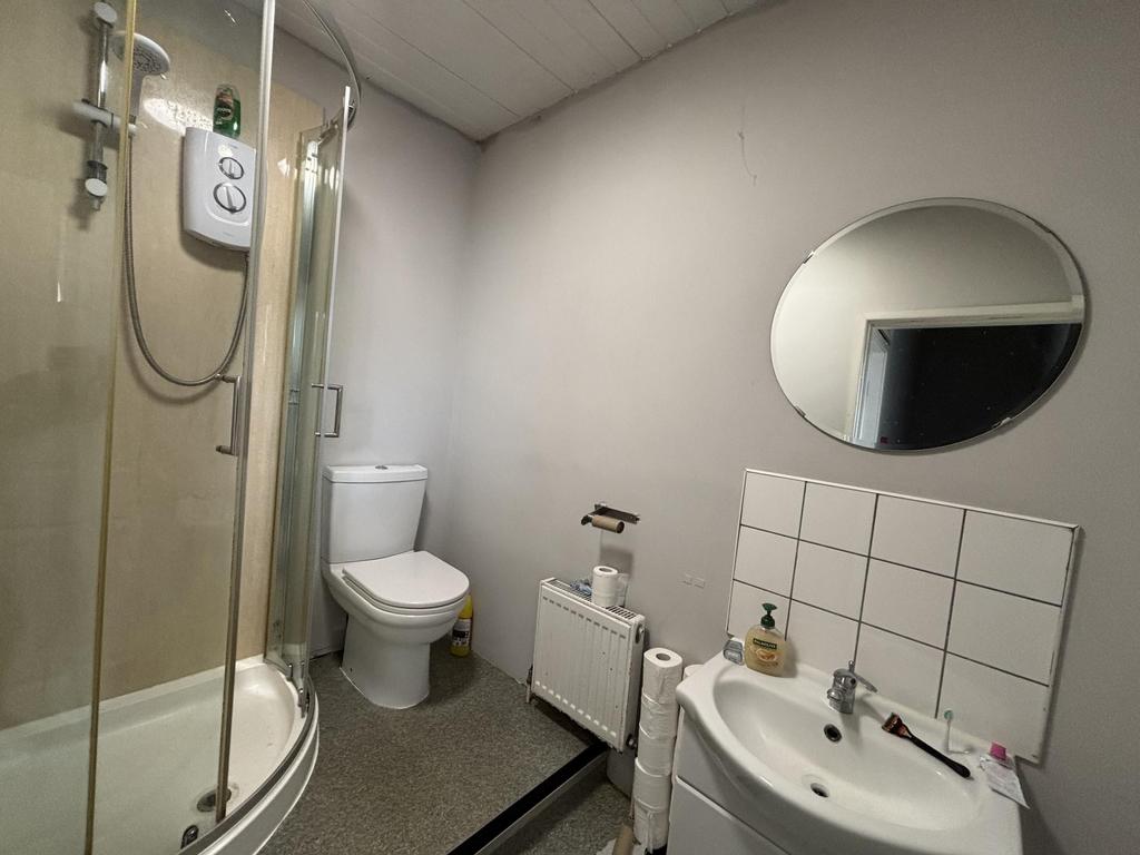 A clean and functional bathroom with a shower, ...