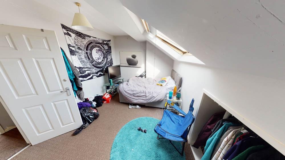 A cozy bedroom with a double bed and a skylight...