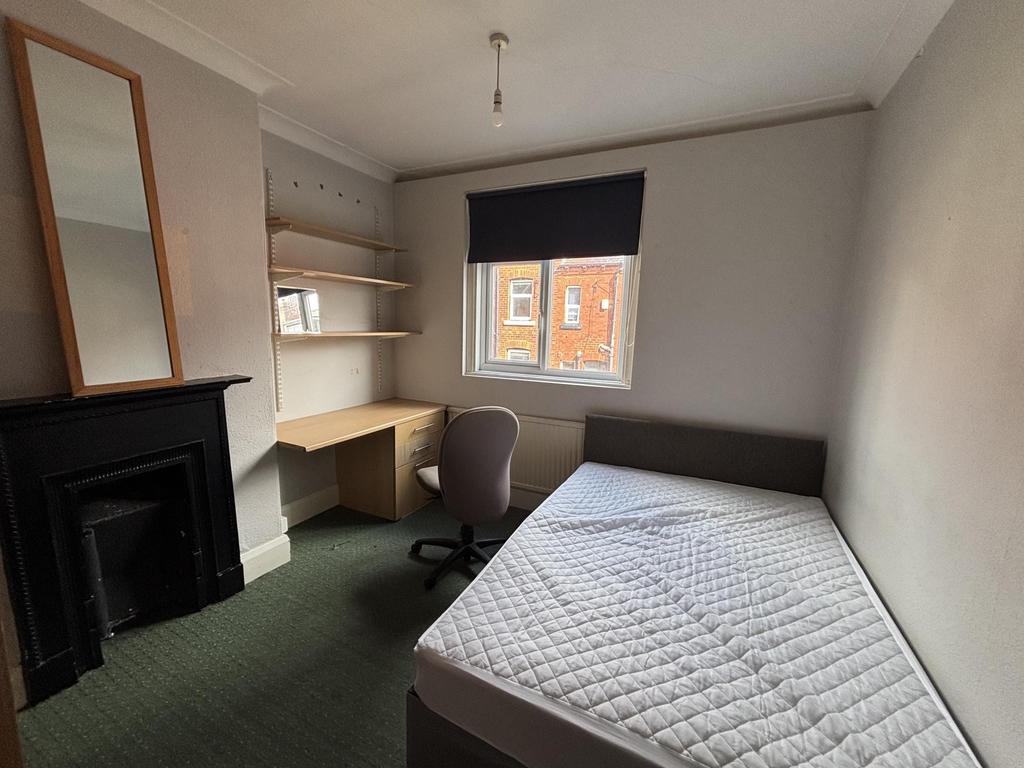 A well-lit, clean double bedroom featuring a co...