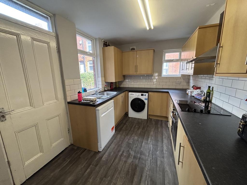A bright and modern kitchen with ample storage ...