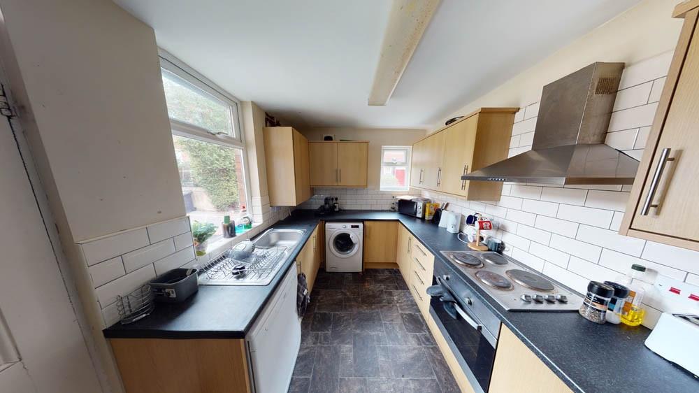 Bright and well-organized kitchen with ample co...