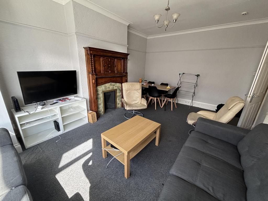 A spacious and well-lit living room featuring c...