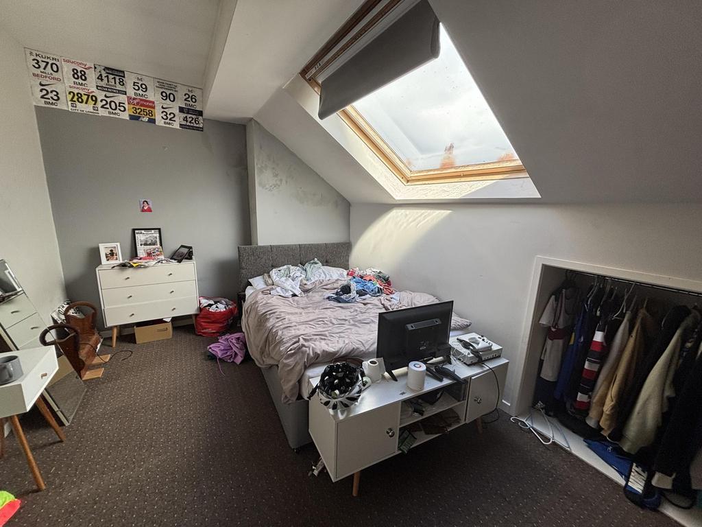 A bright and well-maintained bedroom with a slo...