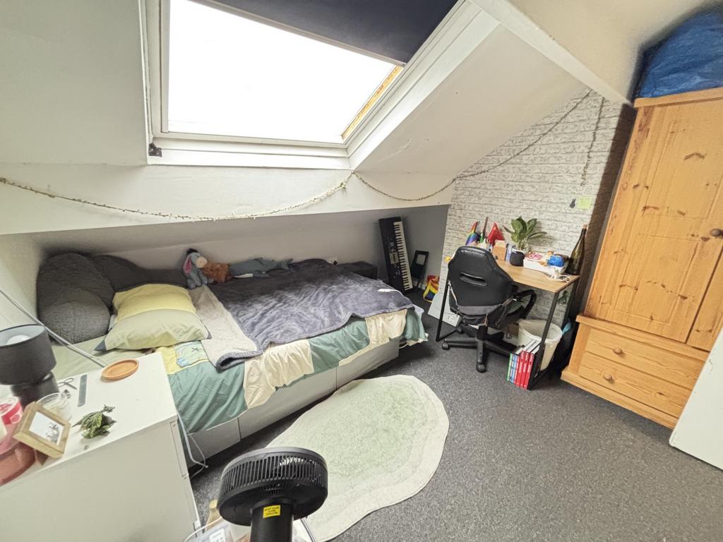 A cozy bedroom featuring a bed with a pillow an...