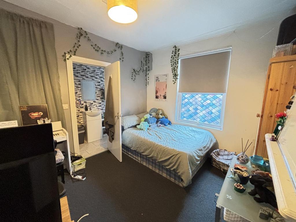 A cozy student bedroom featuring a double bed, ...