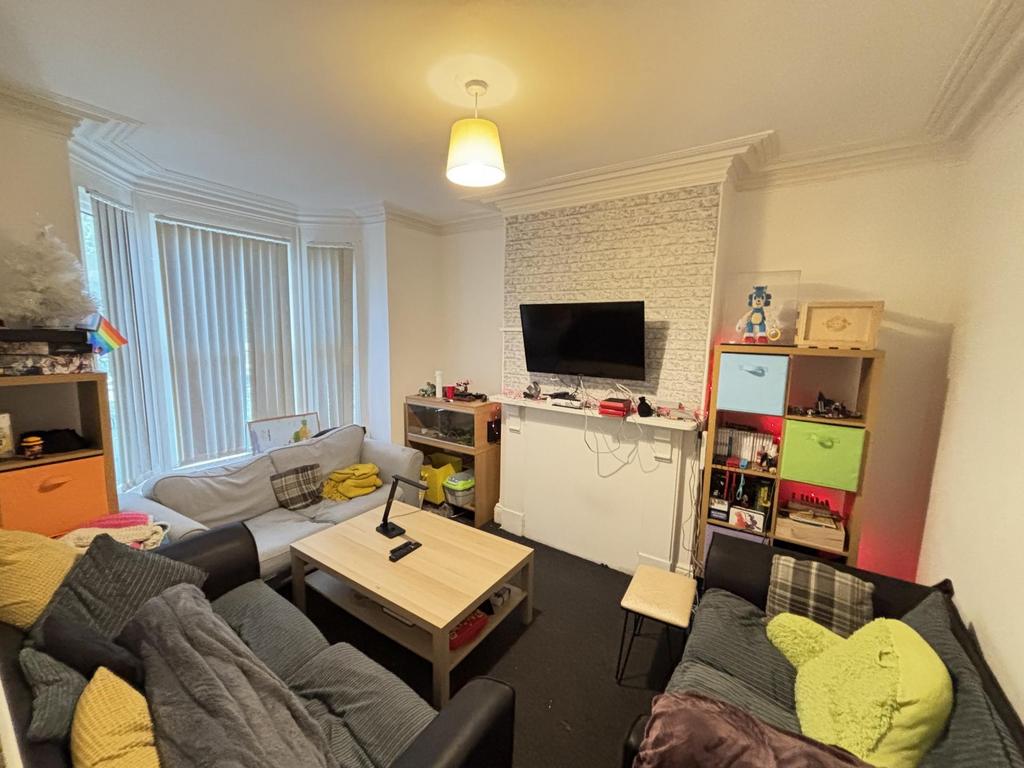 A bright and spacious living room with comforta...