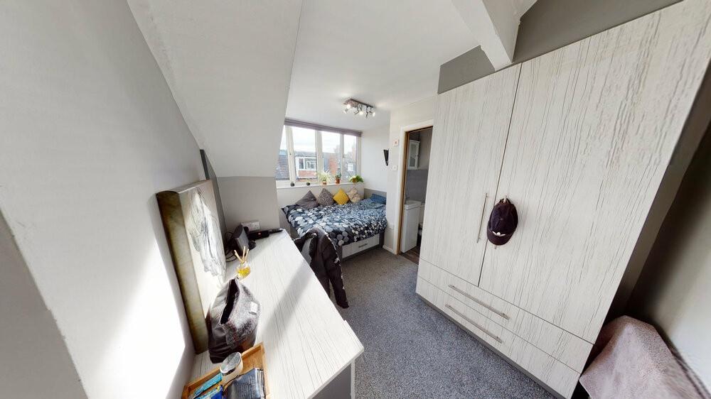 A spacious and well-lit master bedroom featurin...