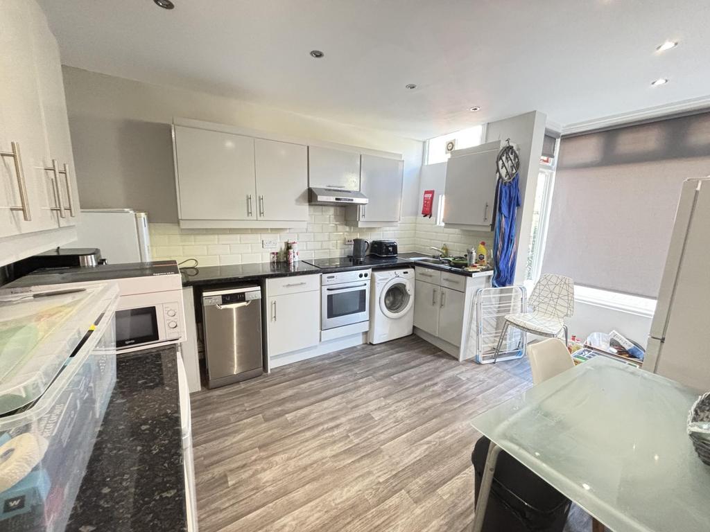 Bright and modern kitchen with ample cabinetry,...