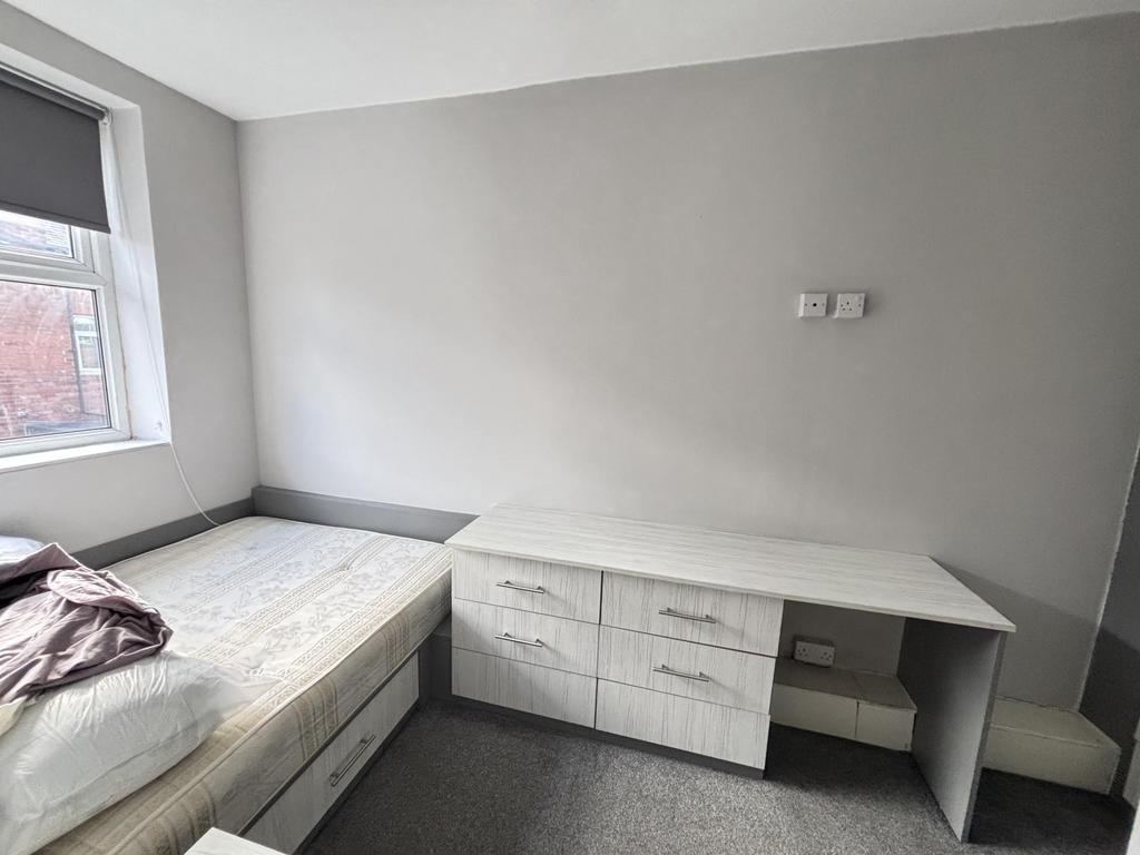 A bright, well-maintained bedroom featuring a s...
