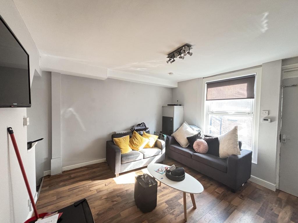 Bright and inviting living room with ample natu...