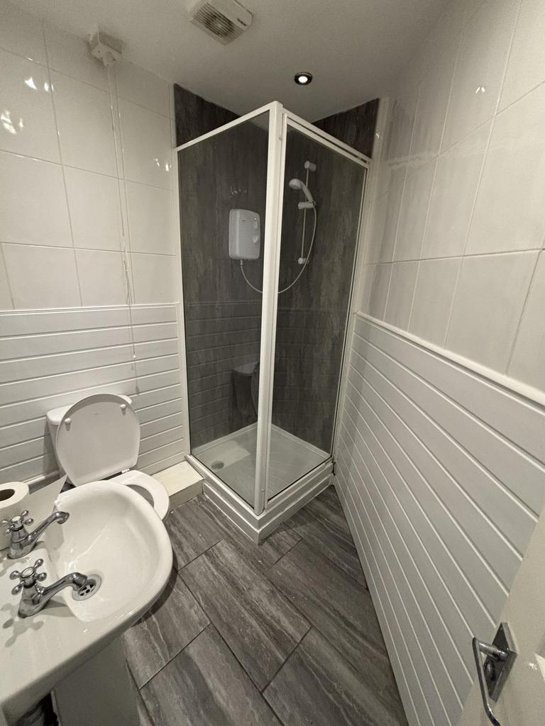 A modern, clean bathroom featuring a spacious s...