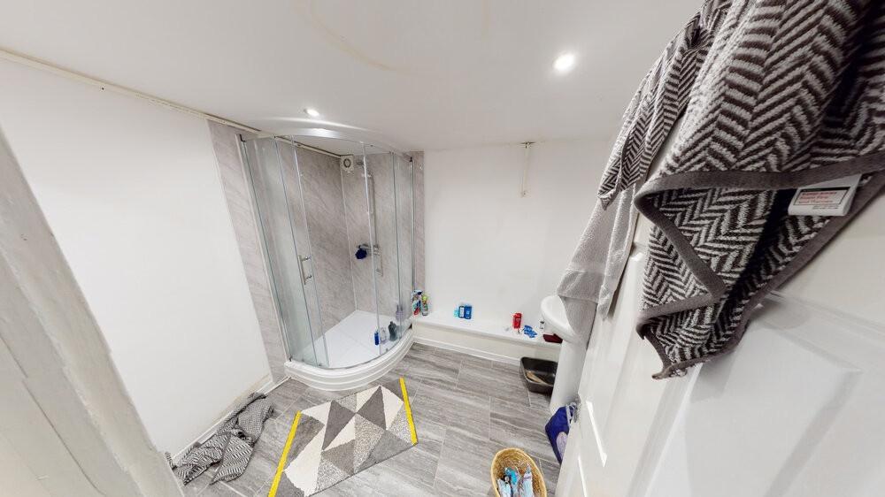 A spacious, modern bathroom featuring a large b...