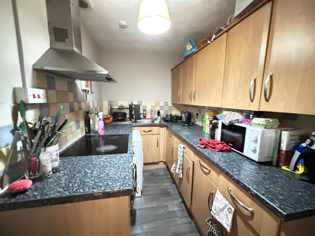 A well-equipped kitchen featuring wooden cabine...