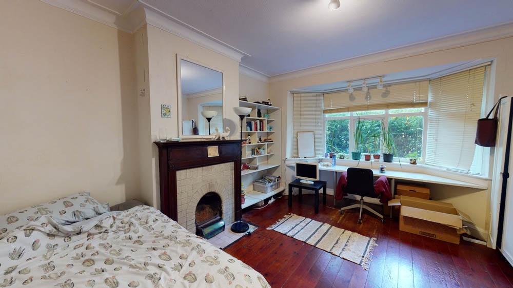 A cozy, well-lit bedroom featuring a double bed...