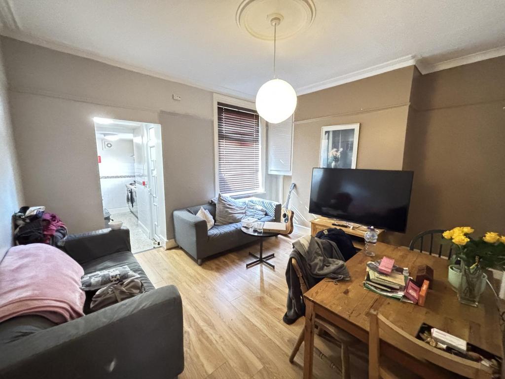 A well-lit, modern living room with comfortable...