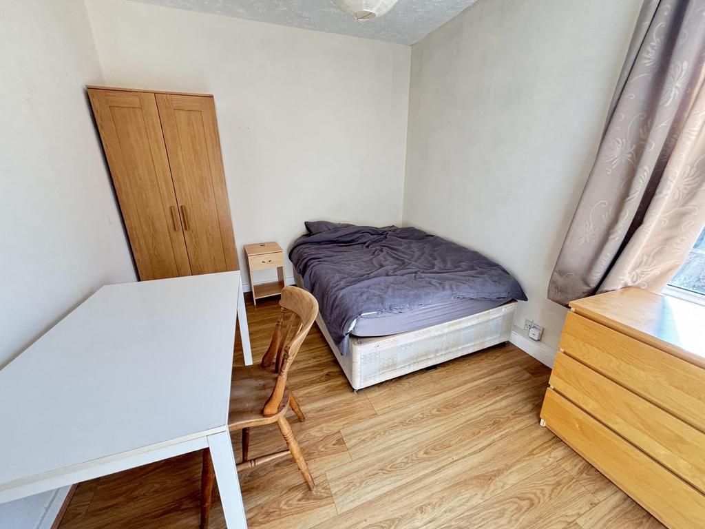A bright and inviting double bedroom featuring ...