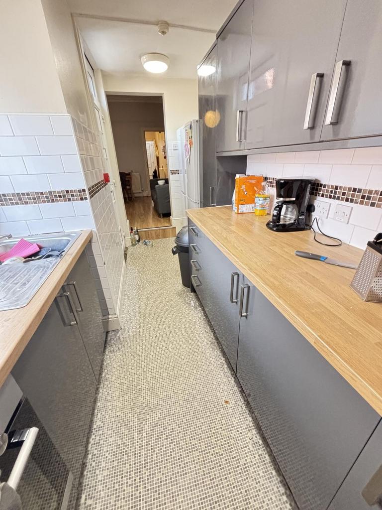 A well-maintained kitchen with modern cabinets,...
