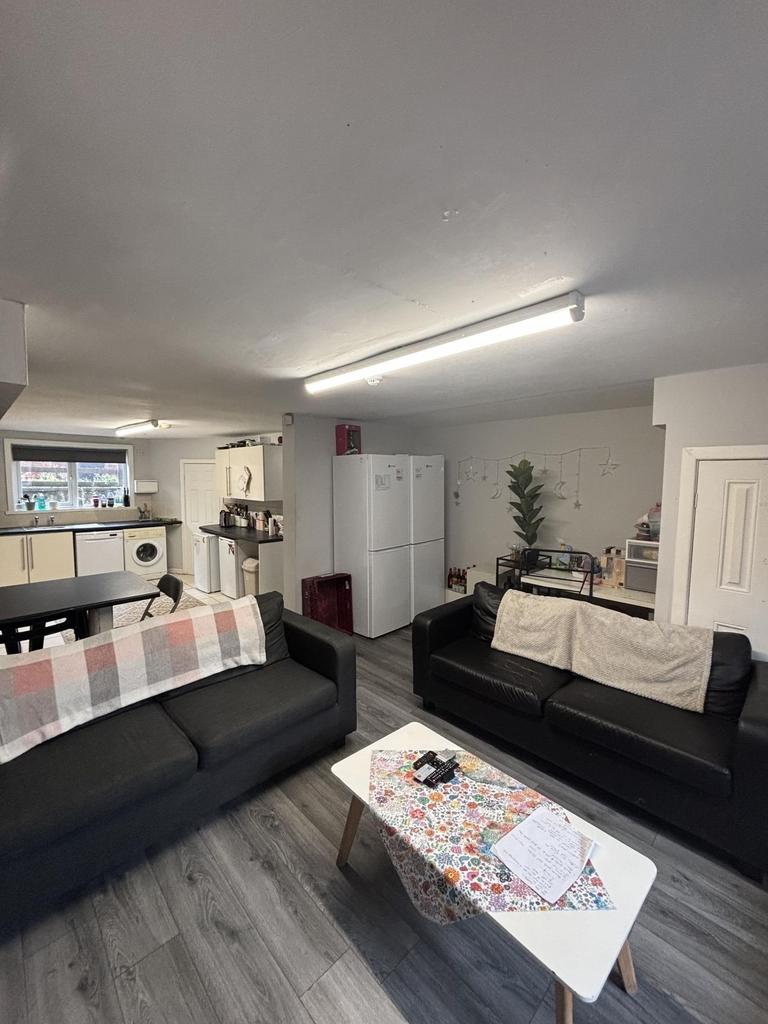 A modern, well-lit living room with comfortable...