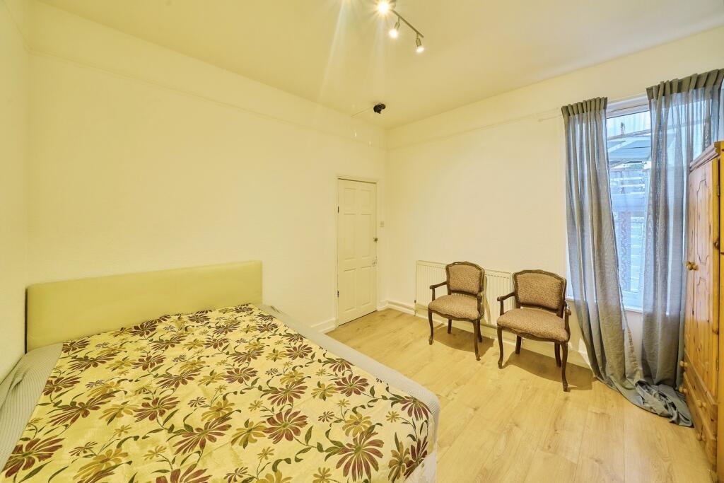 Bright, neutrally decorated double bedroom with...