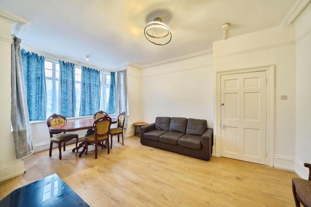 Bright, airy living room with large bay windows...