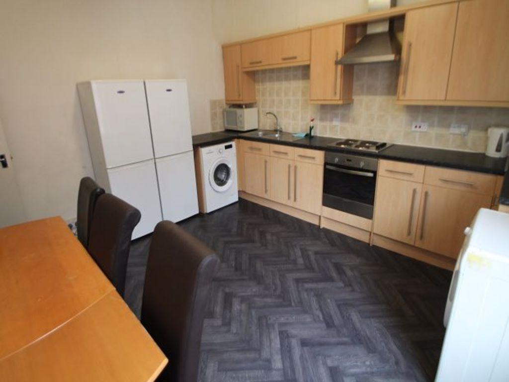 A well-maintained kitchen featuring ample cabin...