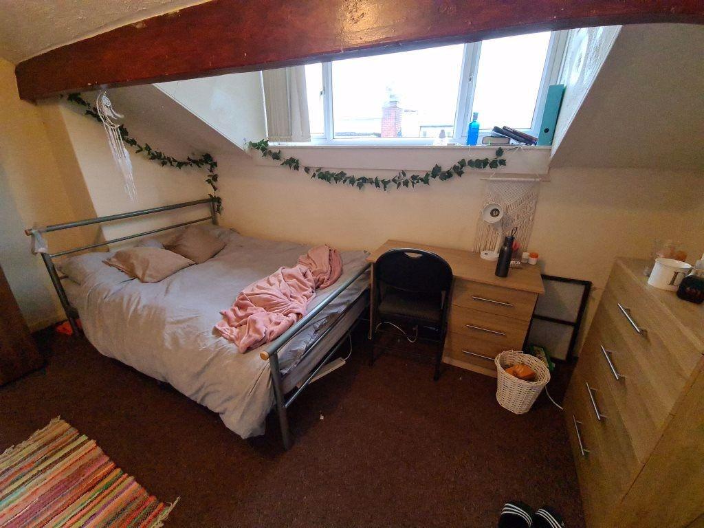 Cozy single bedroom featuring a comfortable bed...