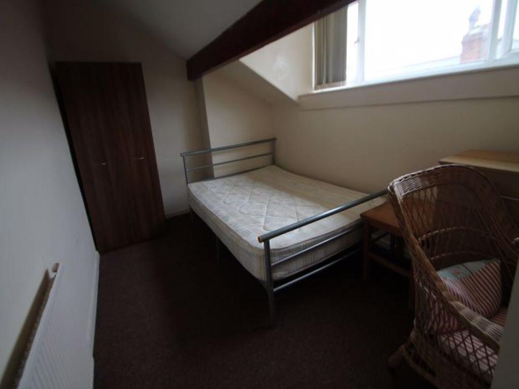 A compact single bedroom featuring a metal bed ...
