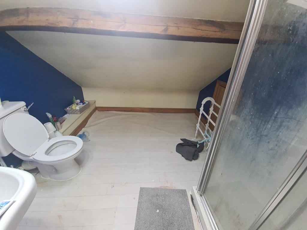 A bathroom featuring a shower enclosure and a t...