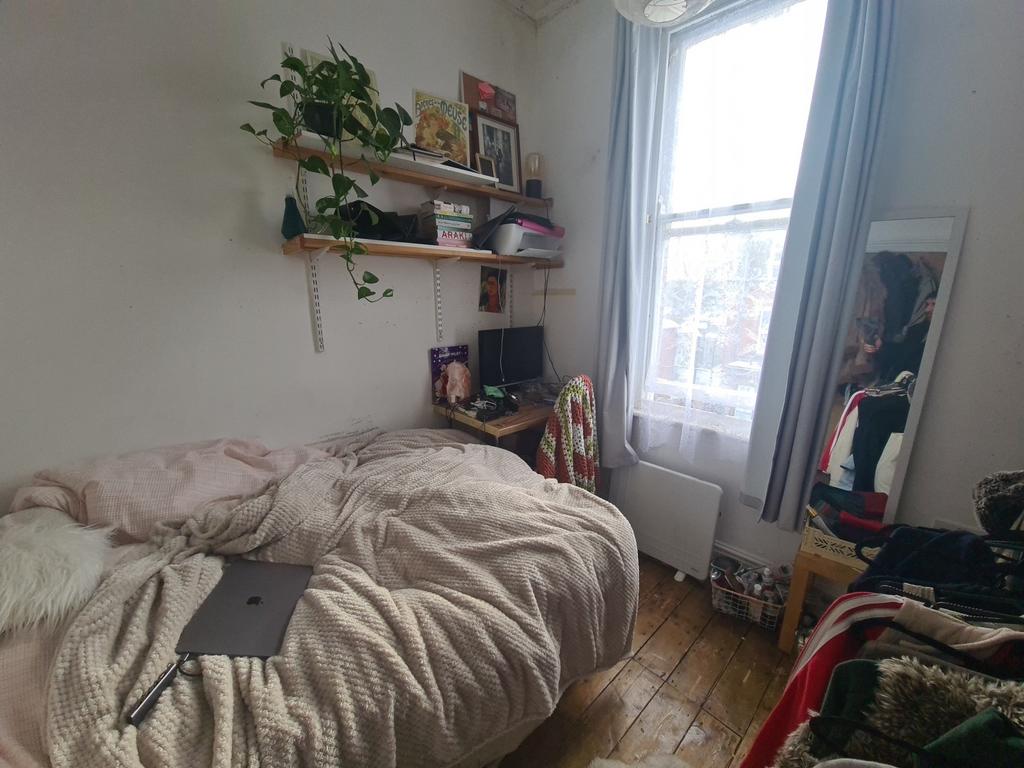 Cozy single bedroom featuring a comfortable bed...