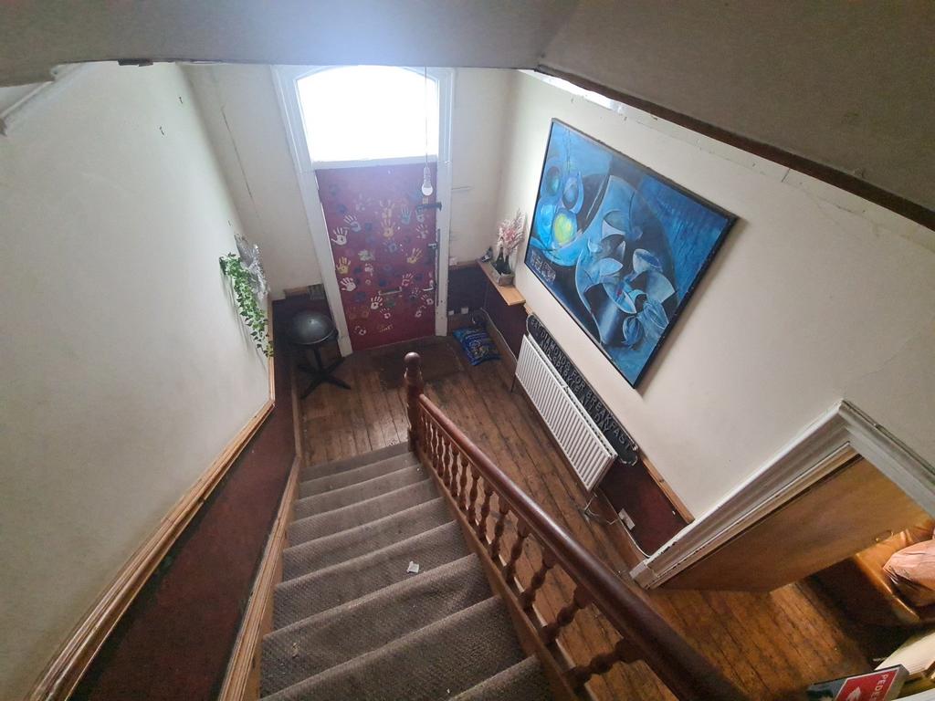 A cozy hallway featuring a carpeted staircase w...
