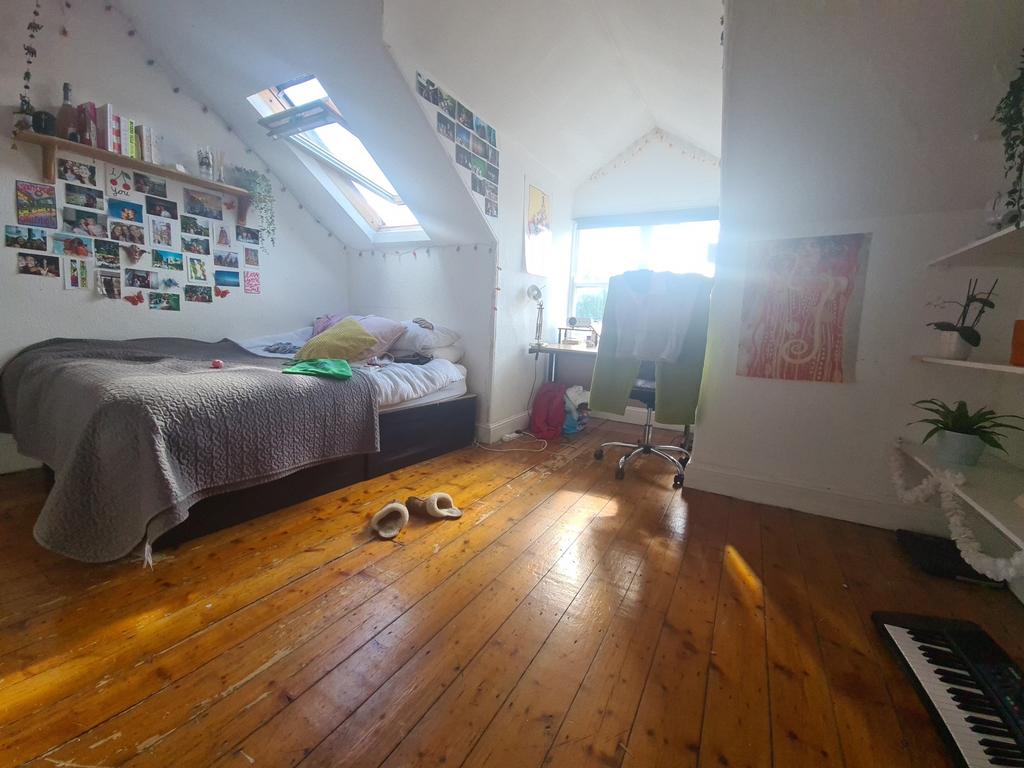 Bright and spacious master bedroom with sloped ...