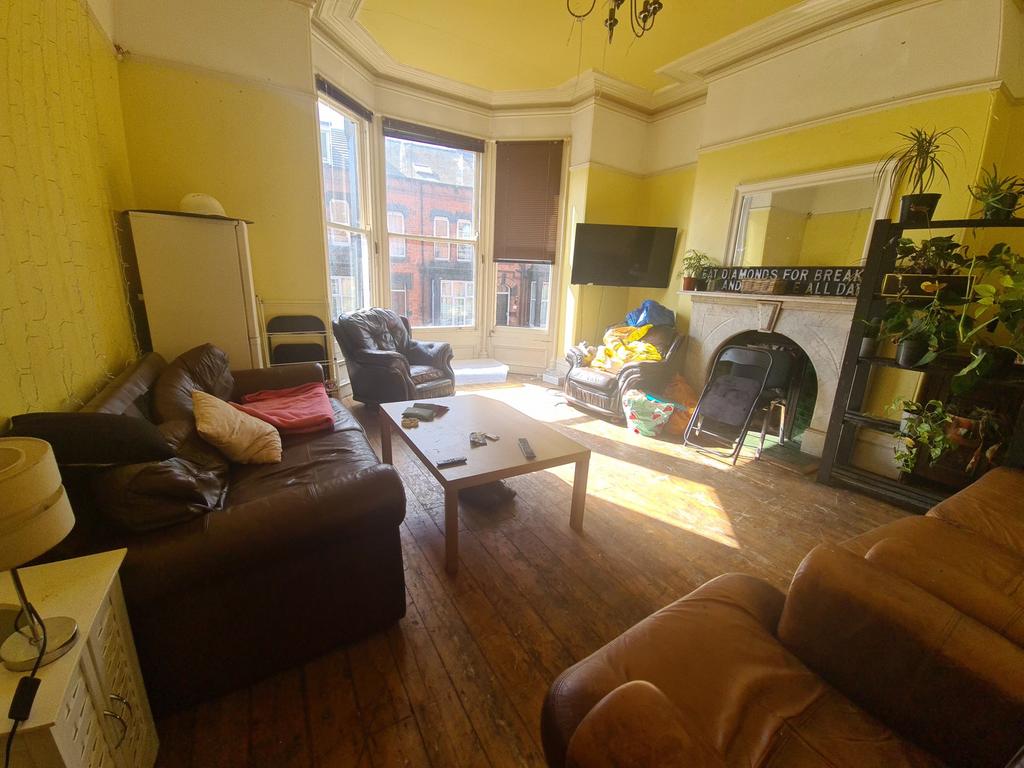 A bright and welcoming living room featuring la...