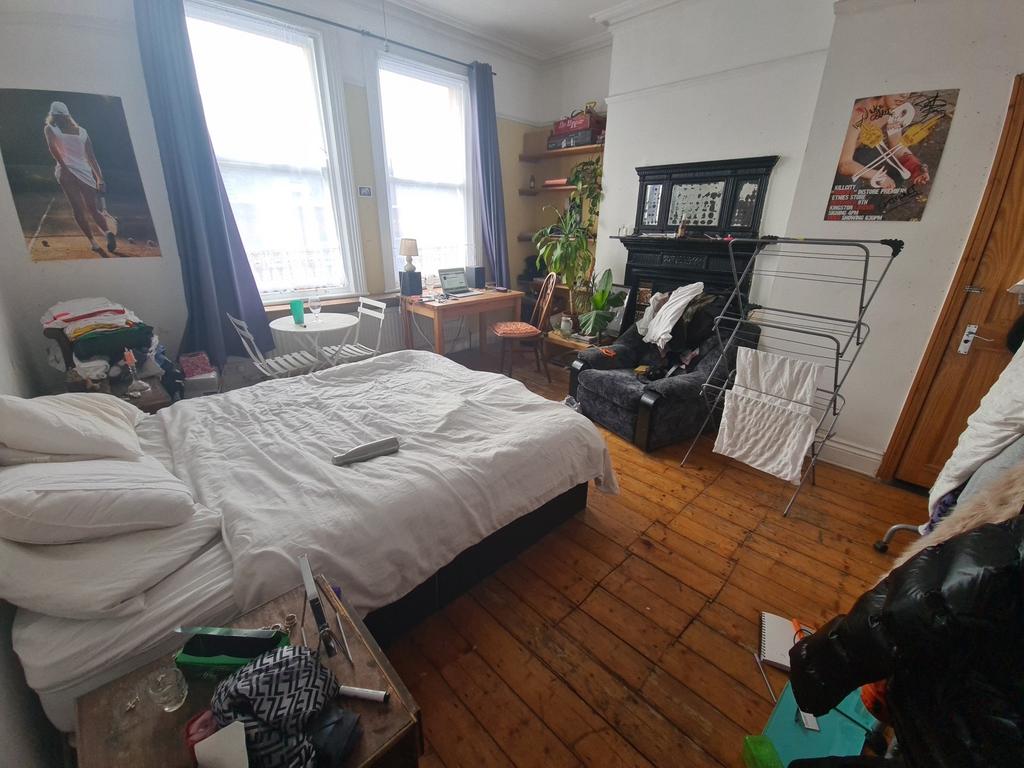 A bright and inviting master bedroom featuring ...