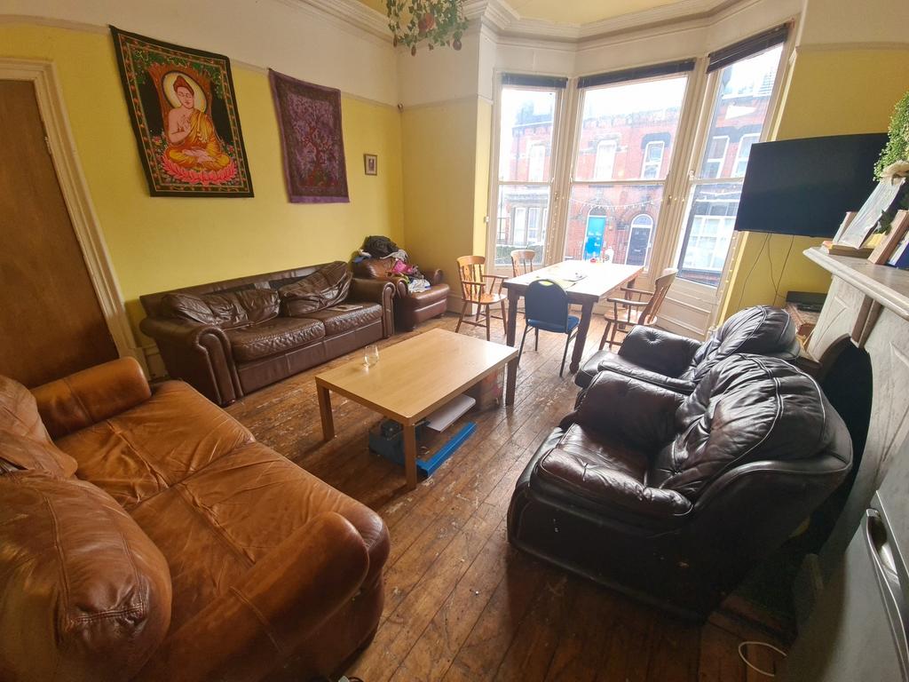 A cozy and inviting living room featuring large...