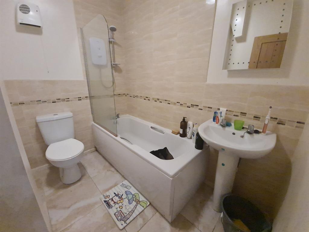 Bright, modern bathroom with a full-size bathtu...