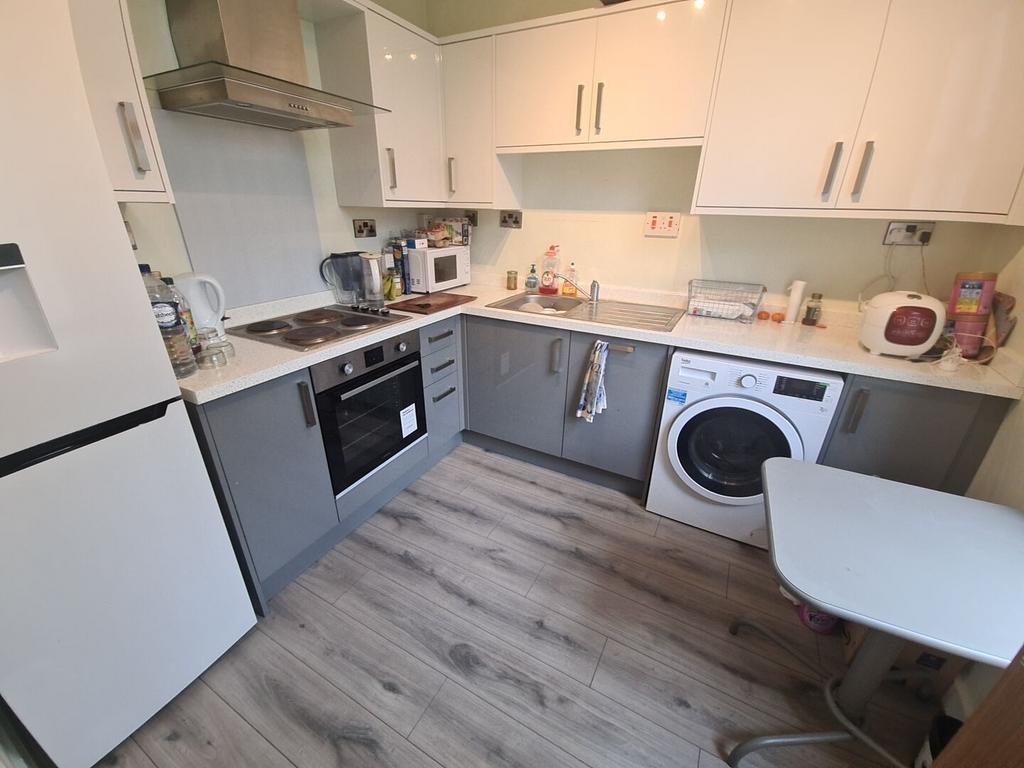 Modern corner kitchen with integrated oven, hob...