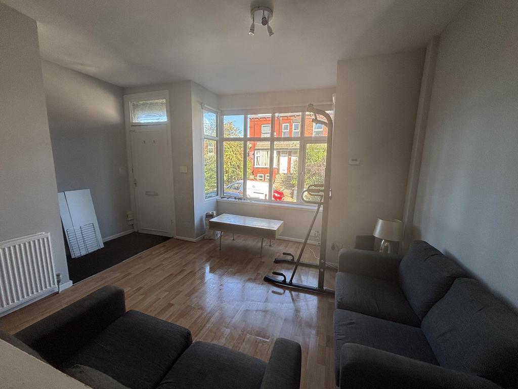 Bright and spacious living room with large wind...