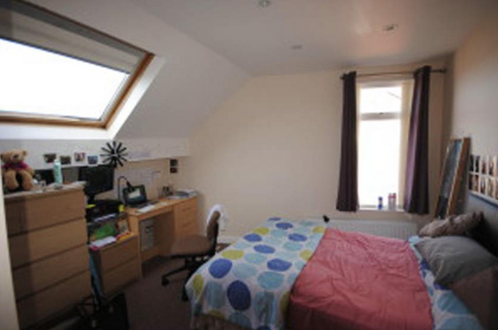 A bright and inviting bedroom featuring a neatl...