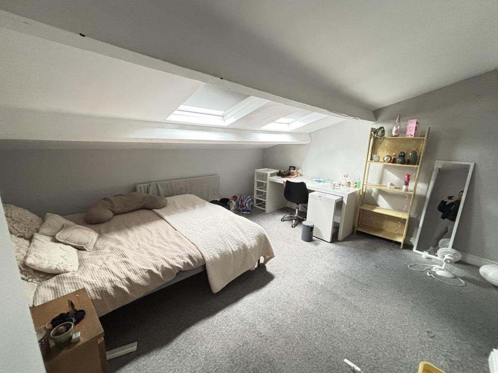 A bright and cozy bedroom with a double bed, fe...
