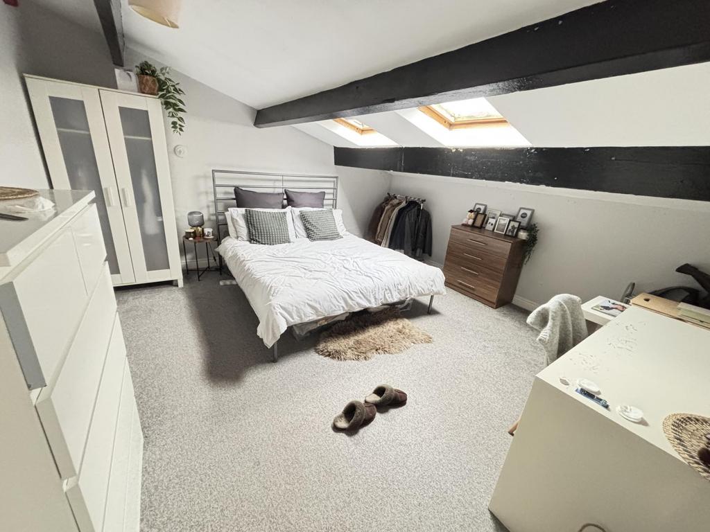 A bright and airy bedroom featuring a large dou...