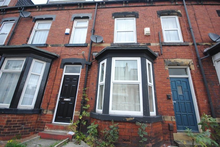 A charming brick exterior with a vibrant blue d...